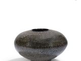 a black and gray vase sitting on a white surface