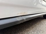 a close up of a car ' s bumper with a dent in it