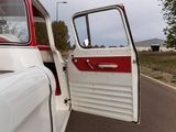a white and red truck with its door open on the road