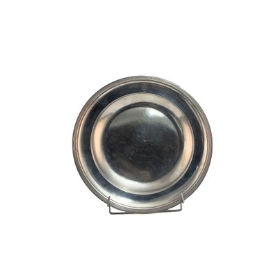 a silver plate on a stand on a white background
