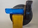 a glass sculpture of a cell phone on a stand