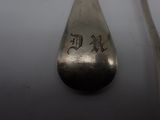 a silver spoon and a silver spoon on a white table