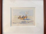 framed watercolor painting of three people in a boat on the beach