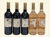 four bottles of wine sitting next to each other on a white surface