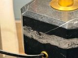 a black marble table with a gold lamp on it