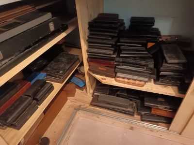many stacks of old electronic equipment on a shelf