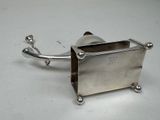 a small silver object that is on a white surface