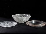 a glass bowl and a glass plate on a table