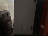 the back of a machine that is sitting in a room