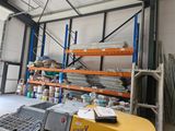 a large warehouse with a lot of shelves and pallets