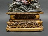 a statue of a man riding a horse on top of a table