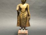 an image of a statue of a person standing on a block