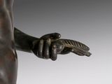 an image of a bronze statue of a man holding a leaf