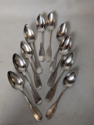 a lot of spoons arranged in a circle on the table