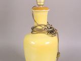 an image of a yellow vase with a light bulb on it