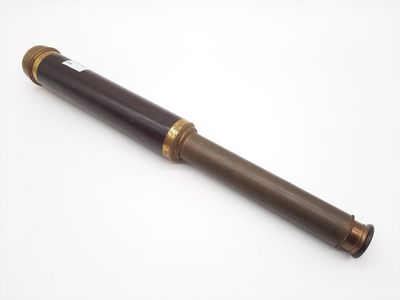 an old telescope on a white surface with a white background