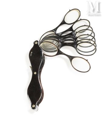 a pair of scissors and a pair of glasses on a white surface