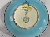a blue and white plate with a picture of a man on it