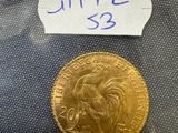 a close up of a gold coin with a label on it