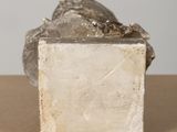 marble sculpture of a woman sitting on a block of stone