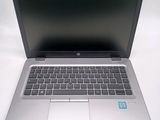 an open laptop computer sitting on top of a white table