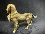 statue of a golden dog on a black background with a black background
