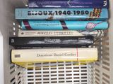 many books in a white basket on the floor