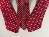 two red ties with blue and red designs on them on a white surface