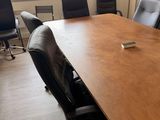 tables and chairs in a conference room with a plant in the middle