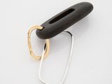 two black and gold rings on a white surface with a white background
