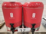 two red coffee urns sitting on top of a counter