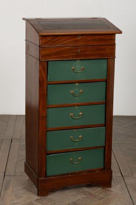 an image of a green chest of drawers on a wooden floor