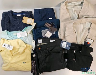 several pairs of men ' s clothing are laid out on a table