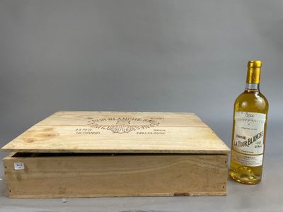 an empty bottle of wine next to a wooden box on a table