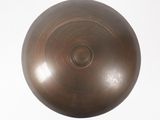 a large metal object that is on a white surface