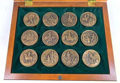 a wooden box with a set of twelve coins in it