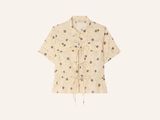 a white shirt with polka dots on it