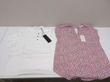 a white shirt and a red and white shirt on a table