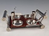 a silver plate with two bowls and spoons on it