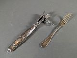 two forks and a knife on a table