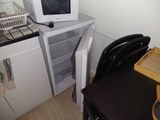 a microwave sitting on top of a refrigerator in a kitchen