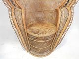 a wicker chair with a basket on top of it
