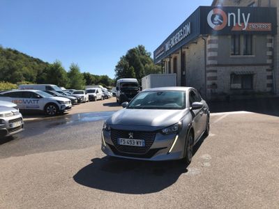 a silver car parked in a parking lot in front of a building