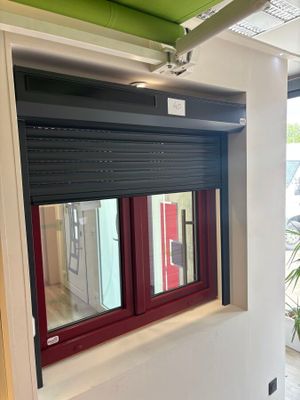 a large window with a red frame in the middle of a room