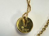 un collier en or muni d'une pièce suspendue à une chaîne