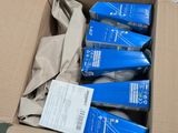 a box full of blue boxes of toothbrushes sitting on a table