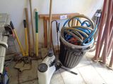 a bucket full of hoses and other tools in a room