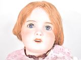 a close up of a doll with red hair and blue eyes