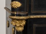 a black and gold cabinet with a marble top
