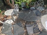 a table and chairs that are outside in the yard